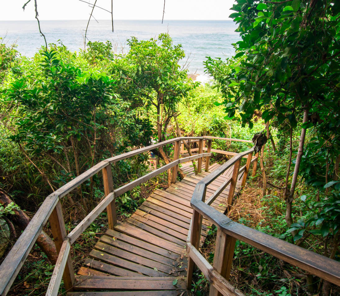 Iconic cliffside viewpoint at Cabo San Juan with colorful hammocks overlooking twin beaches and turquoise waters in Tayrona National Park
