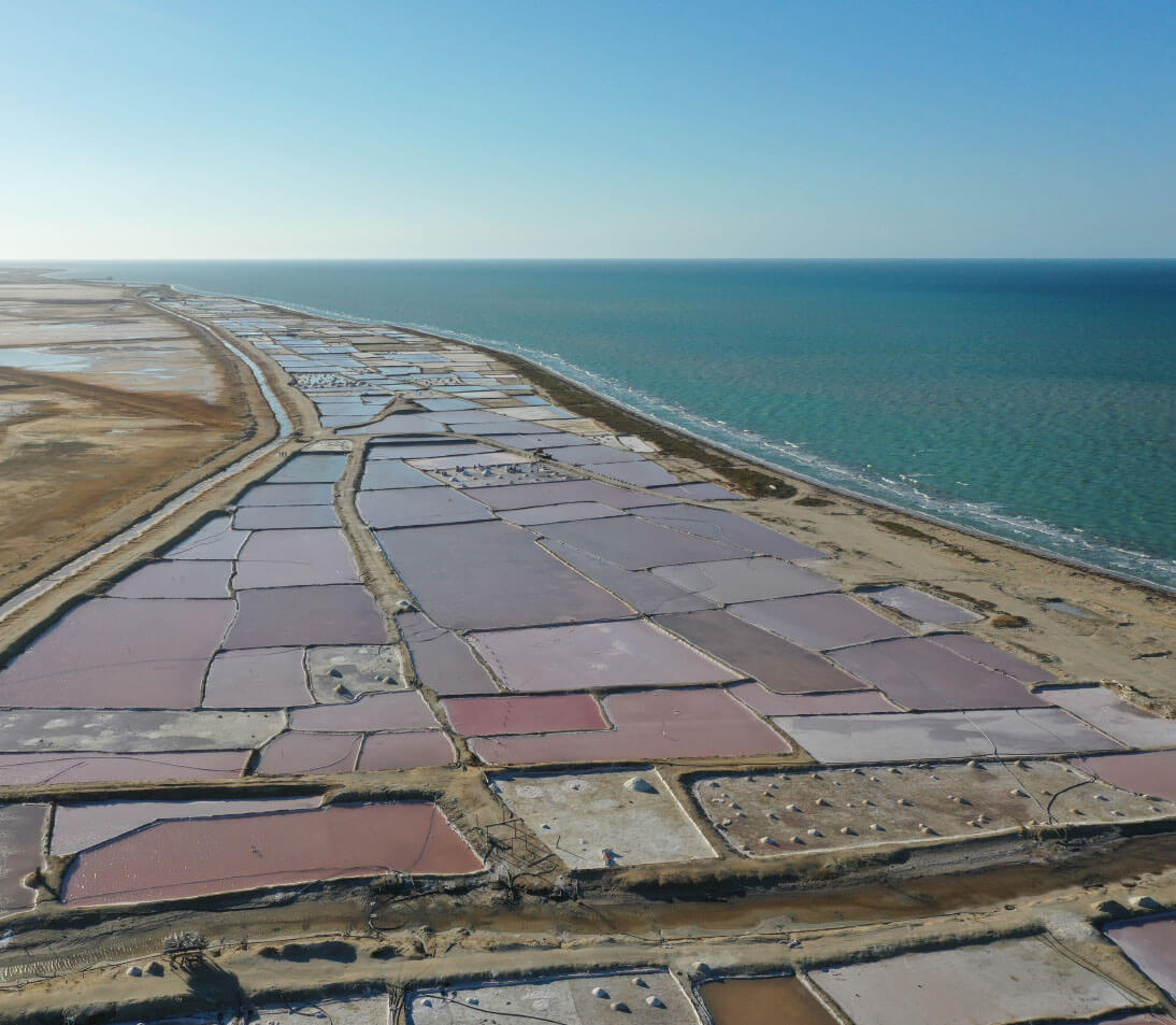 Stunning desert landscape of Punta Gallinas with red sand dunes contrasting against deep blue Caribbean waters