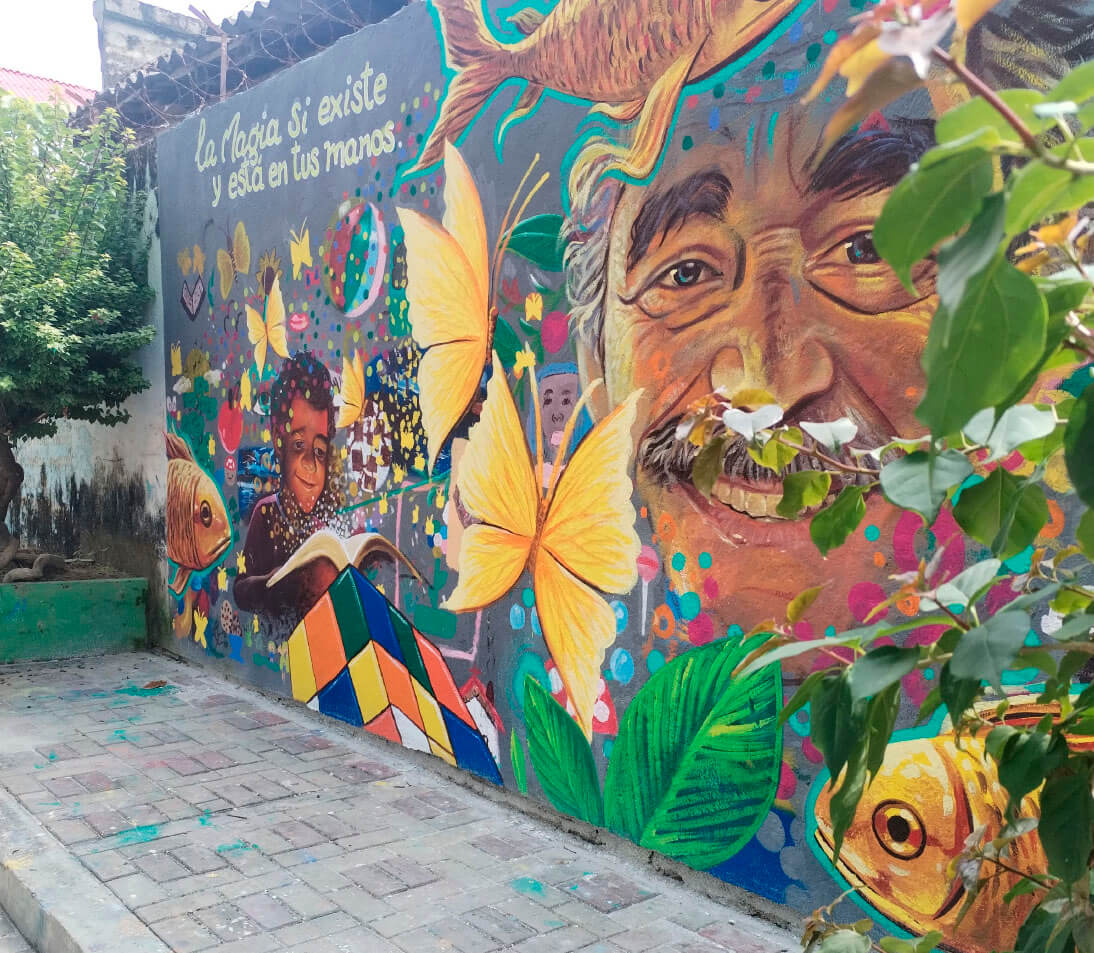 Vibrant street art mural depicting Gabriel García Márquez in Aracataca town center, Magdalena Colombia