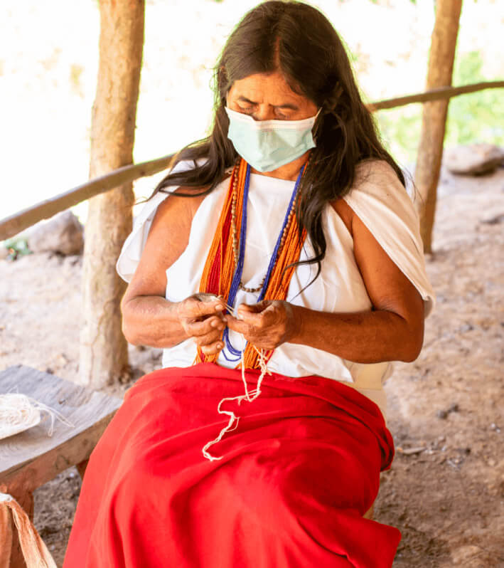 Wiwa indigenous woman weaving traditional handicrafts in Gotsezhy community, Sierra Nevada de Santa Marta